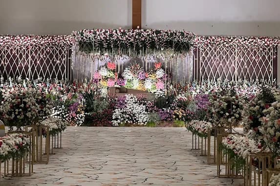 A flower-dressed stage set for a reception at SS Conventions