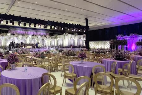 Round tables set for dinner under the canopy at SS Conventions