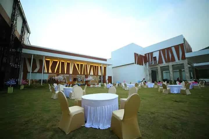 Tables set on the lawn outside CK Conventions in daylight