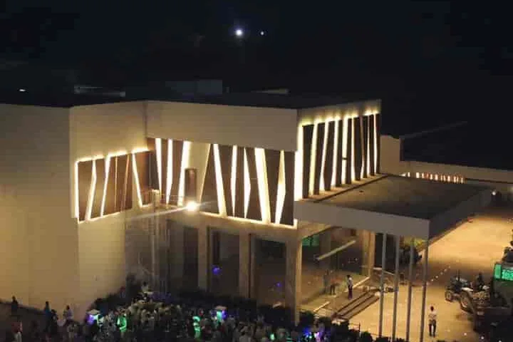 The facade of CK Conventions lit for an evening function